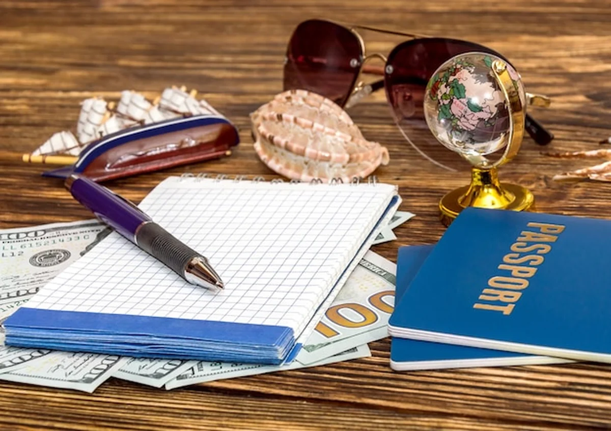 Koncepcja podróży: Paszporty, pieniądze i notatnik na stole