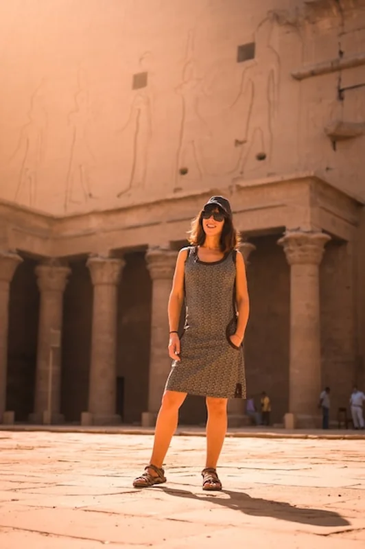 Młody turysta w czapce przy świątyni Edfu o wschodzie słońca w Asuanie